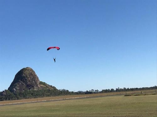 a person is flying a kite in a field at Akubra Downs, Yeppoon -Cottage 3 bedroom in Cawarral