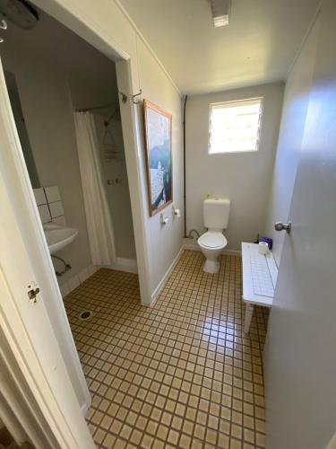 a bathroom with a toilet and a sink at Akubra Downs, Yeppoon -Cottage 3 bedroom in Cawarral