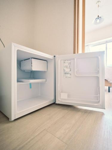 an open refrigerator with its door open in a room at vetta kumamoto suizenji 401 in Kumamoto