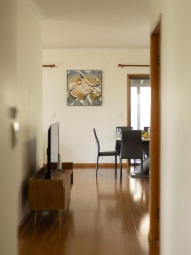 a living room with a tv and a table at Spacious Land Area 5Bedroom Home at Sunnybank New AC in Brisbane
