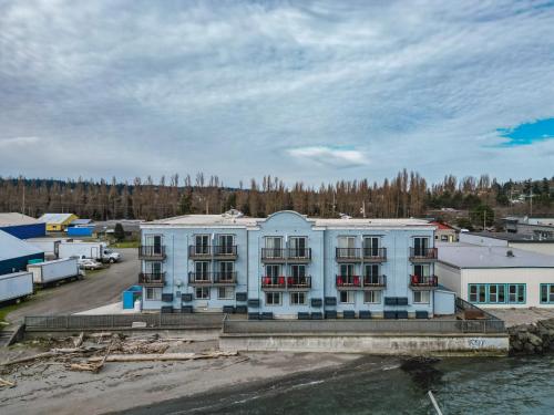 a large white building next to a body of water at Water Front Inn in Port Townsend