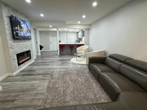 a living room with a couch and a fireplace at HansBnB near Airport in Calgary