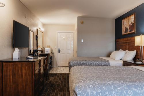 a hotel room with two beds and a television at Water Front Inn in Port Townsend