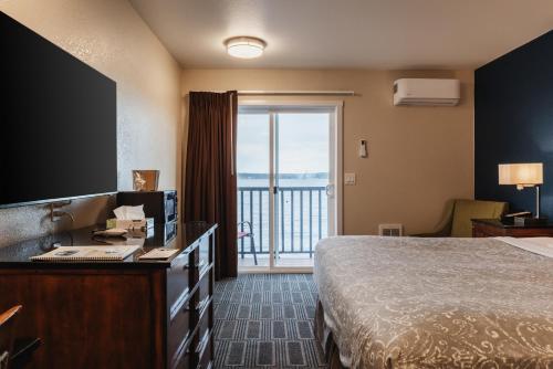 a hotel room with a bed and a large window at Water Front Inn in Port Townsend