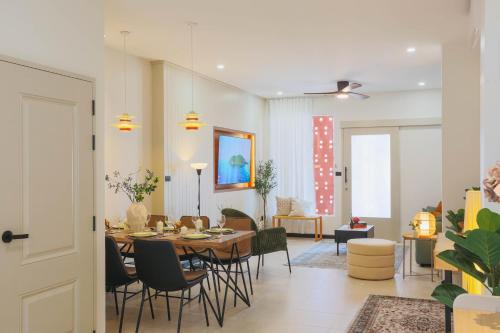 a dining room and living room with a table and chairs at Sea Breeze Villa Patong in Patong Beach