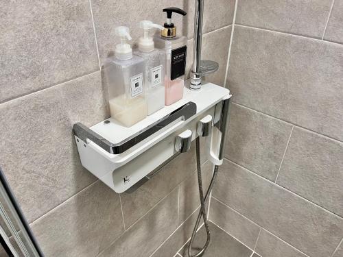 a bathroom with a soap dispenser on a wall at The First Hyoistay Gwangan in Busan