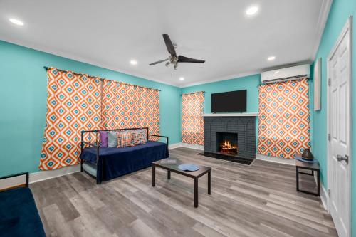 a living room with a couch and a fireplace at Quirky & Chic 3BR in Montrose - Perfect for Families & Groups in Houston
