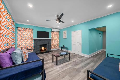 a living room with a couch and a fireplace at Quirky & Chic 3BR in Montrose - Perfect for Families & Groups in Houston