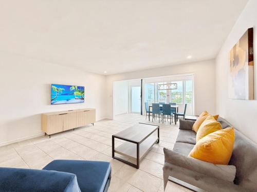a living room with a couch and a table at Crystal Cove Sapphire Beach - Spacious Condo, Pool Tennis WiFi in East End