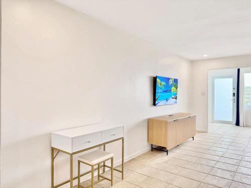 a white room with a desk and a cabinet at Crystal Cove Sapphire Beach - Spacious Condo, Pool Tennis WiFi in East End