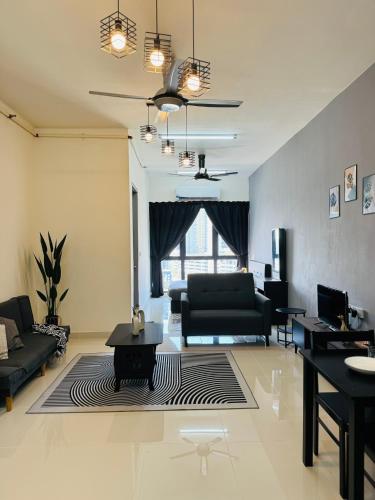 a living room with a black couch and a table at Core Soho Suites Kota Warisan Sepang KLIA Airport Free Wifi by BKA LEGACY in Sepang