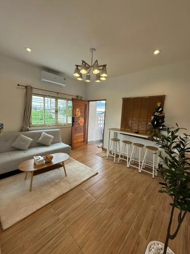 a living room with a couch and a table at 19 House in Ban Khlong Pleo