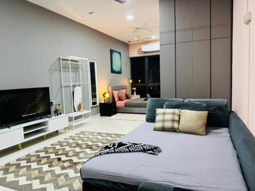 a living room with a couch and a flat screen tv at Core Soho Suites Kota Warisan Sepang KLIA Airport Free Wifi by BKA LEGACY in Sepang