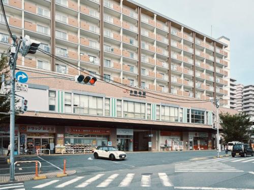 a white car parked in front of a large building at vetta kumamoto suizenji 406 in Kumamoto