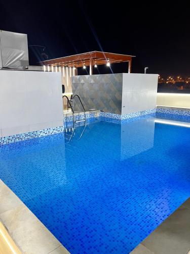 a large swimming pool with blue tiles on it at Hotel Gboss in Punta Hermosa