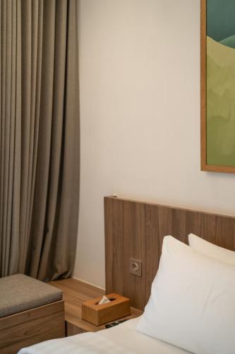 a bedroom with a bed and a curtain at Dusun Bedugul Asri in Bedugul