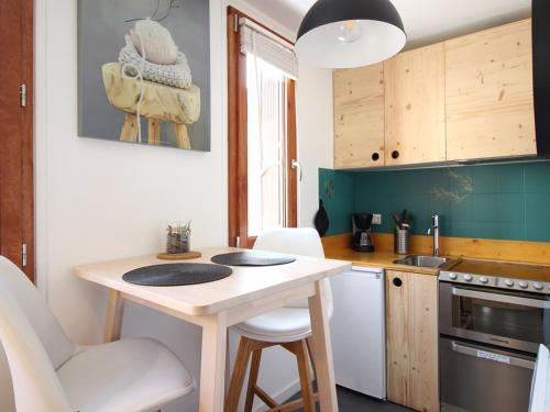 - une petite cuisine avec une petite table et des chaises dans l'établissement Studio au rez-de-chaussée avec parking privé et WIFI illimité, à proximité du centre. - FR-1-415-118, à Le Mont-Dore