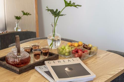 a table with a tray of fruit and a tablet on it at Lane Wisdom Garden Hotel - Lijiang Ancient City Zhongyi Market in Lijiang