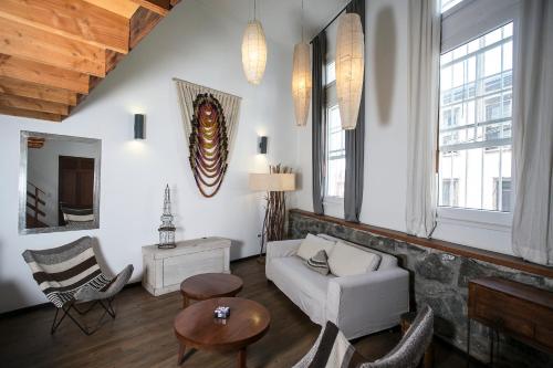 a living room with a couch and a table at Casa Galos Hotel & Lofts in Valparaíso