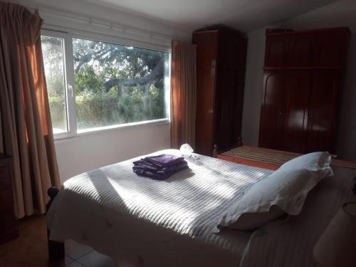 En eller flere senge i et værelse på La Paz Casa de campo