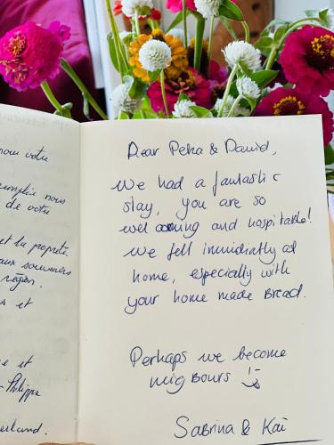 a page of a book with flowers in the background at Tutukaka Sunrise in Tutukaka