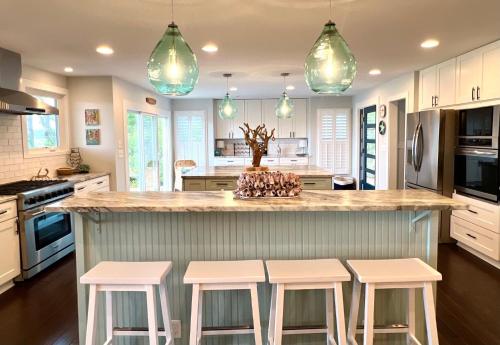a kitchen with a counter with four stools around it at 2420 Seabrook Island Rd in Johns Island