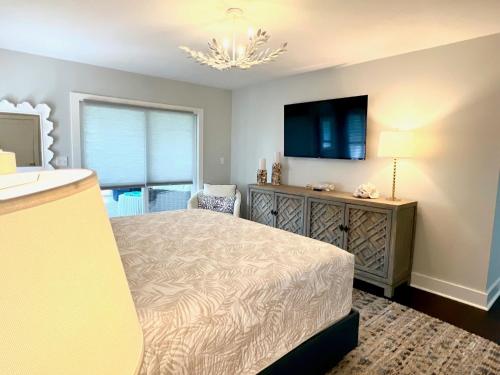 a bedroom with a bed and a sink and a television at 2420 Seabrook Island Rd in Johns Island