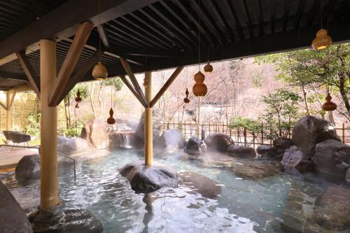a pool of water with rocks in a zoo at TAOYA Kawaji in Nikko