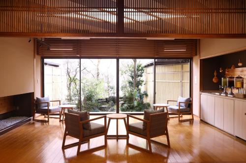 a room with tables and chairs and a large window at TAOYA Kawaji in Nikko