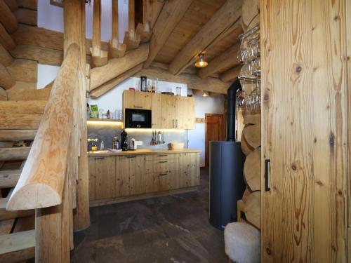 a kitchen with wooden cabinets and a refrigerator at Chalet in Wildkogel with Ski-In Ski-Out in Bramberg am Wildkogel