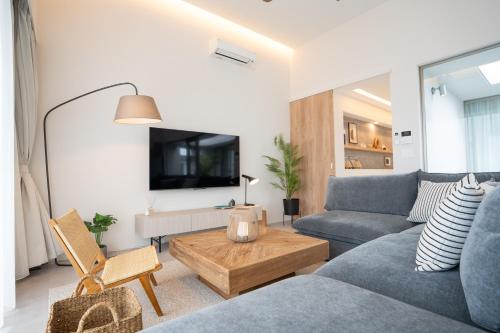 a living room with a couch and a table at Tamagusuku Terrace in Nanjo