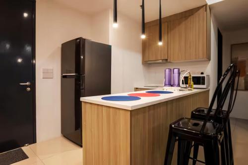 a kitchen with a counter and a refrigerator at Tropicana 218 Macalister Penang in George Town