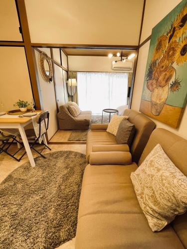 a living room with a couch and a table at Best Shinjuku Modern Full-furnished Family size Apartment5 ONLY 2min to Shinjuku by Train in Tokyo