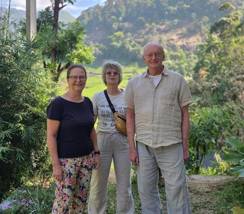 a man and two women standing next to each other at Forestscape Resort Munnar in Munnar