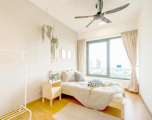 a white bedroom with a bed and a window at Tropicana 218 Macalister Penang in George Town
