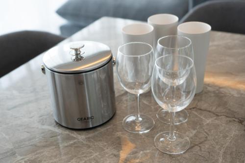 three wine glasses and a can on a table at Tamagusuku Terrace in Nanjo
