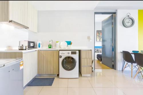 a kitchen with a washing machine in the middle at Tropicana 218 Macalister Penang in George Town