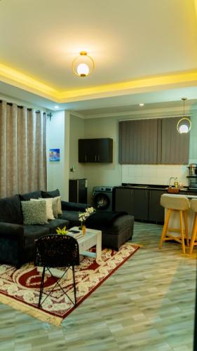 a living room with a couch and a table at Serene Homes 02 in Kampala