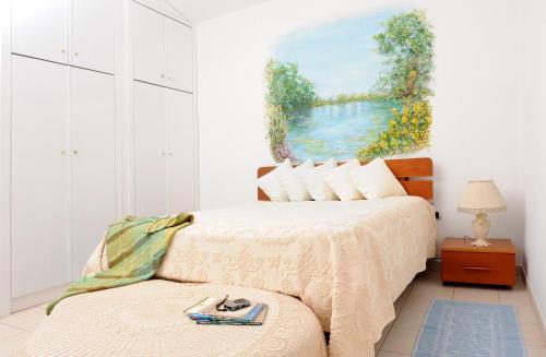 a bedroom with a bed with a painting on the wall at Il Giardino di Valentina in Escolca