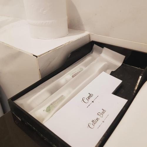 a white cake in a black box with a candle at Victory Hotel Jakarta in Jakarta