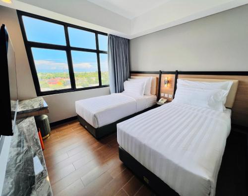 Ένα ή περισσότερα κρεβάτια σε δωμάτιο στο d'primahotel Airport Sultan Hasanuddin Makassar