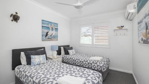 a bedroom with two beds and a window at Water Views on Wallawa in Nelson Bay