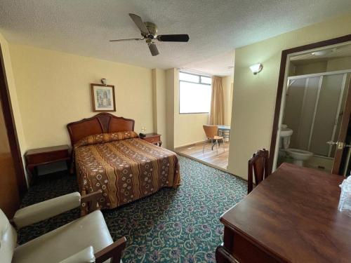 a hotel room with a bed and a bathroom at MariaCristina in San Luis Potosí