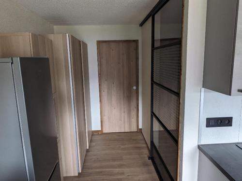 une chambre vide avec un couloir et une porte en bois dans l'établissement Studio confortable à Châtel avec WiFi et parking couvert - FR-1-676-215, à Châtel
