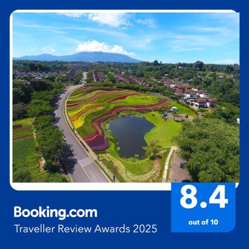 an aerial view of a golf course with a lake at Vimala Hills Resort Cozy Villa Puncak Gadog Bogor in Bogor