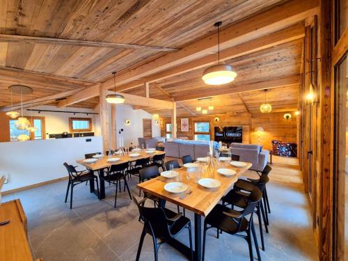 une grande salle à manger avec des plafonds en bois, des tables et des chaises dans l'établissement Chalet individuel spacieux aux Gets pour 12 personnes, 5 chambres - FR-1-671-287, aux Gets