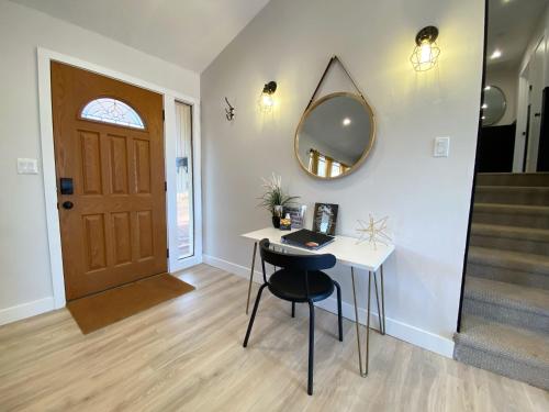 a room with a desk and a mirror and a door at Pax Sacellum Kanab Home for Southern Utah Hiking in Kanab