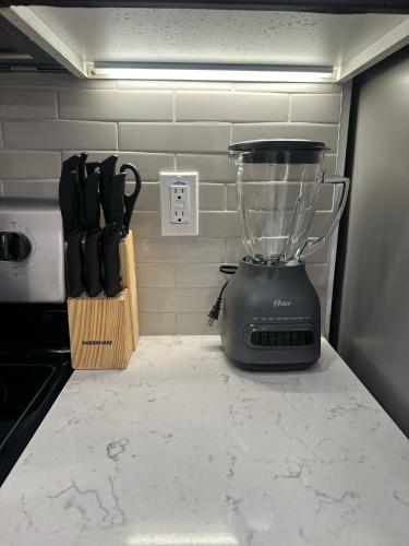 a blender sitting on top of a counter with knives at Cozy Loft Sunset FRRE WIFI and DESIGNATED Parking in Los Angeles