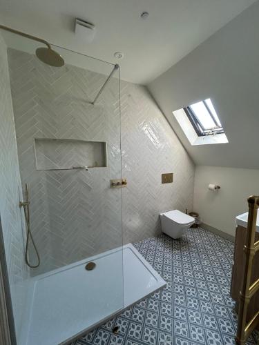 a bathroom with a shower and a toilet at Dukes Flat in Ampney Saint Peter
