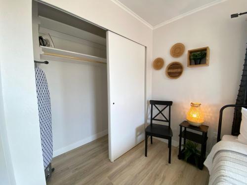 a bedroom with a sliding door and a bed and a chair at Pax Sacellum Kanab Home for Southern Utah Hiking in Kanab